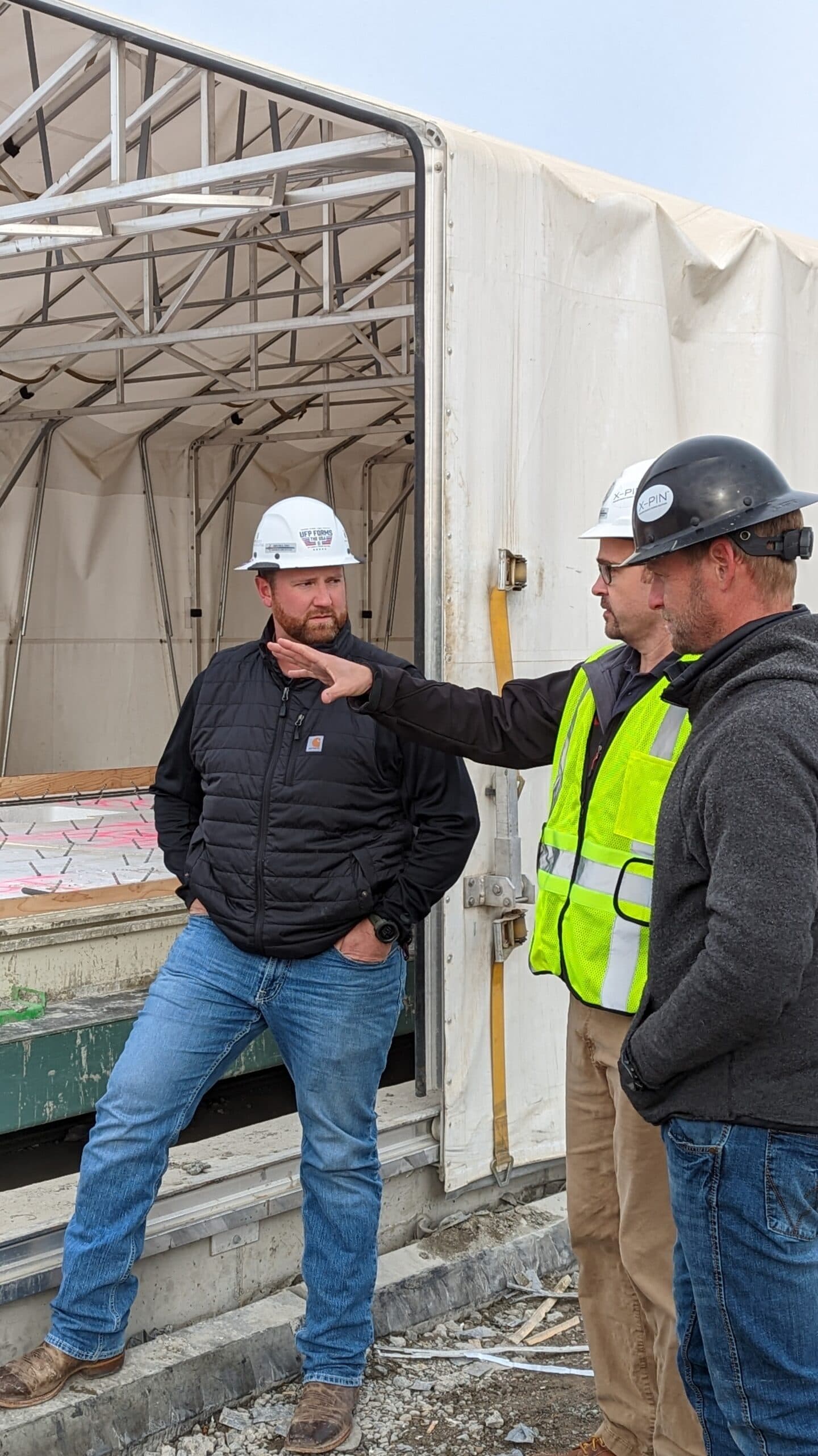 UFP Concrete team members consulting on a precast production floor